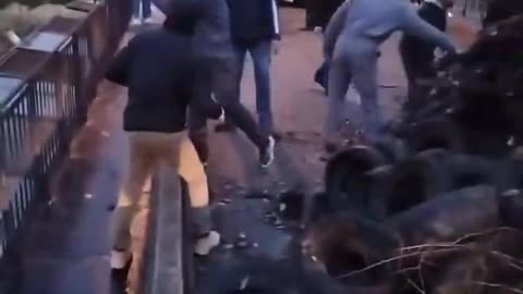 French farmers throw tires and refuse off a bridge onto high speed rail tracks