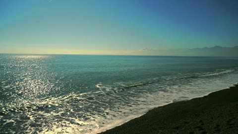 Ocean Serenade: Waves on a Black Sand Beach