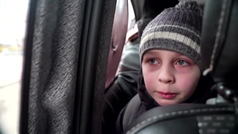 'We left our Dad in Kyiv' -little boy chokes back tears