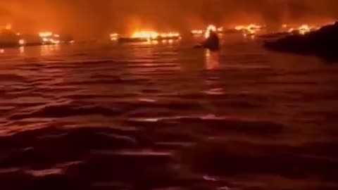 View from the harbor as fire destroys buildings in Maui