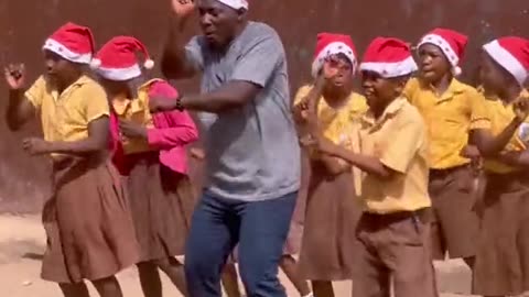 Ghanaian Teacher dances with his students