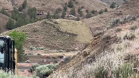 Construction Workers Demolish A Hilltop