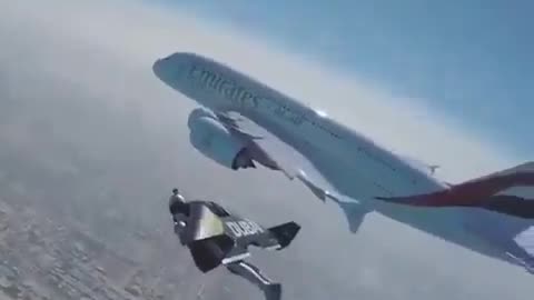 Jetman in Dubai flying next to an Emirates A380!