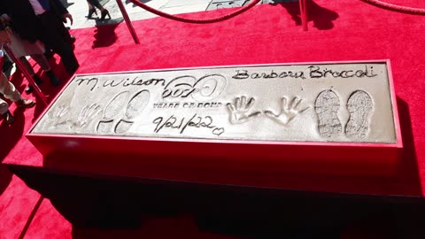 Michael G. Wilson and Barbara Broccoli place their handprints in cement in Hollywood