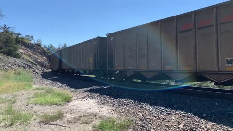 Solid EMD SD70ACe lineup up Mullan Pass. 3 BNSF, 4 MRL, then 1 BNSF on the rear.