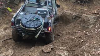 Toyota 4x4 bends rusty frame on rock (watch rollbar)