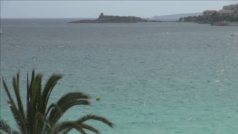 teal water off spanish shore