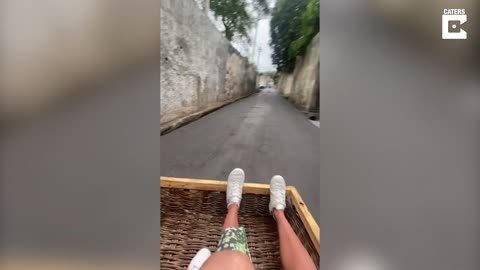 Tourists Ride Wooden Toboggan Down Hills In Madeira