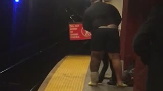 Guy takes off his pants in subway station