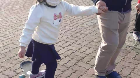 Cute baby riding a skateboard.