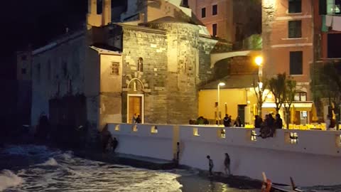 Kids playing at the waters edge in Vernazza, Italy