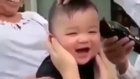 See how the baby is smiling while cutting the hair।