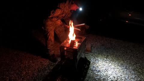 Lighting a campfire in a firepit.