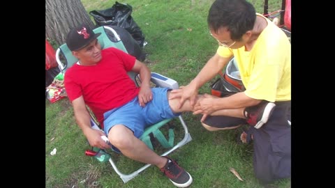 Luodong Massages Mexican Man's Knee At The Gender Reveal Party