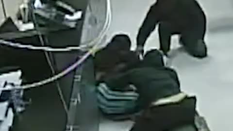 Security footage captured two masked men breaking through the ceiling of a check-cashing