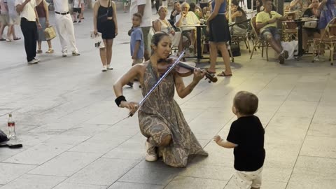 Street Violinist Enchants Young Boy