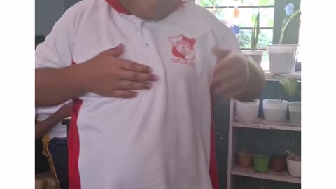 A boy shows his talent Infront of his teacher and students