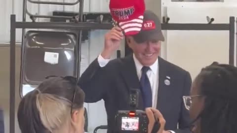 BIDEN PUTS ON TRUMP HAT