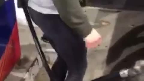 Girl in green tries to jump over gas pump and falls down