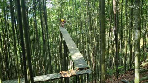 Beautiful Girl building a tent on top of a bamboo tree- at forest Wild Girl