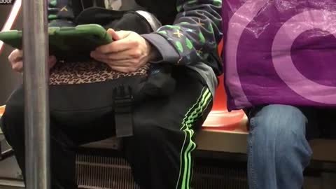 Man headphones green ipad dancing sitting subway train