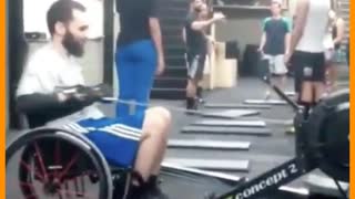 man in wheelchair doing exercises