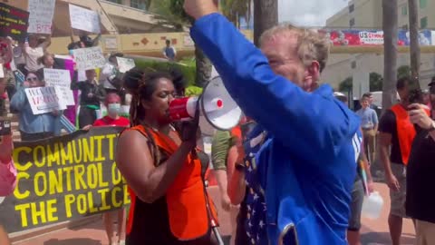 Anti-DeSantis protesters make some noise outside of the TPUSA event in Tampa, Florida.