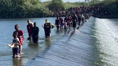 Thousands Of Migrants Walk Over Dam To Enter Del Rio, Texas