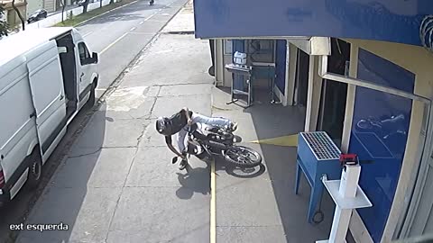 Guy Trying to Ride on Motorcycle Falls and Rolls on the Ground