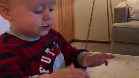 Little kid black and red striped shirt playing games on phone