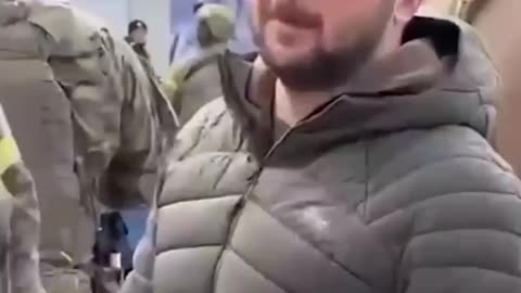 Woman raises a Russian flag right to Zelenskys face.