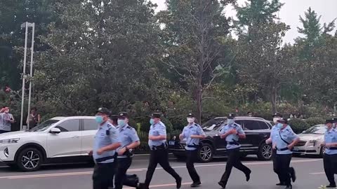 Protesters tussle with People's Bank of China security