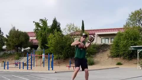 Man Throws Football And Dribbles Basketball While Balancing On a Slackline