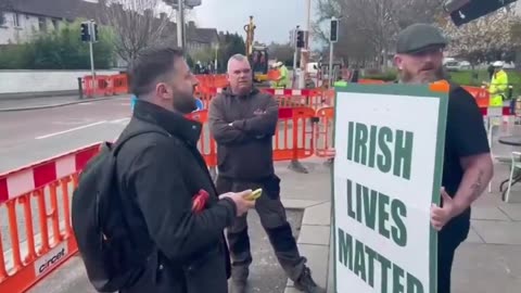 Irish patriot protests peacefully outside the headquarters of a company that