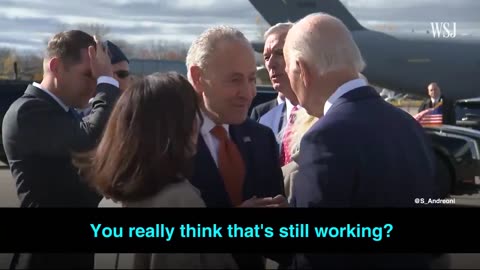 Senator Chuck Schumer is talking with the fake masked Biden about delaying legislation