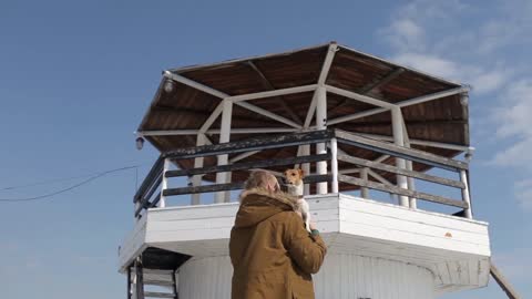 Beautiful Girl Holding Jack Russell by the Lighthouse