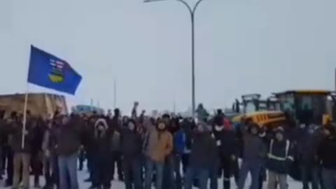 Truckers chant for freedom as they await the RCMP