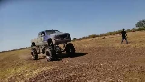 Monster truck hammers camera guy with rocks and dirt