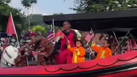 Boy accidentally points middle finger during parade