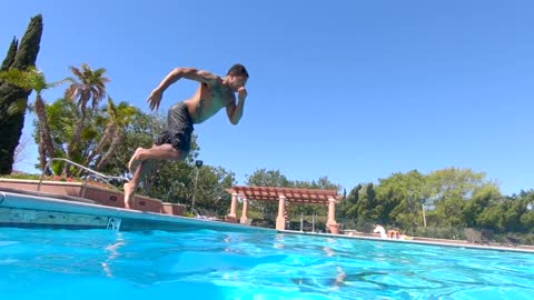 A Man Diving Into The Swimming Pool