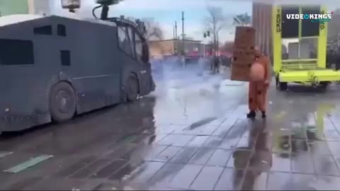 Dutch Riot Police test their Water Cannon on a woman at anti-night-curfew protests in Eindhoven