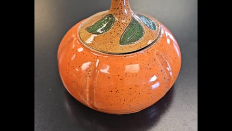 Making a pumpkin on the pottery wheel.