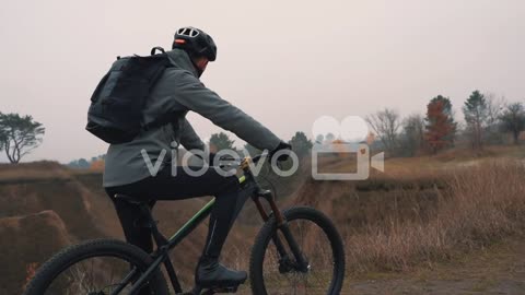 Athlete Man Riding A Mountain Bike In The Hill