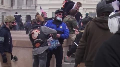 J6: cop passing out water to the crowd