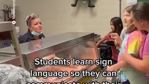 Students learn sign language so they can communicate with their deaf cafeteria worker