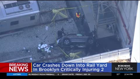 Car crashes down into Brooklyn rail yard.