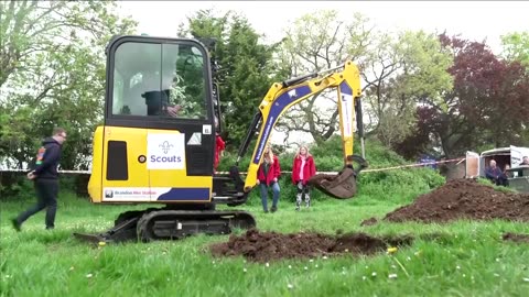 Britain's Prince Louis helps operate digger