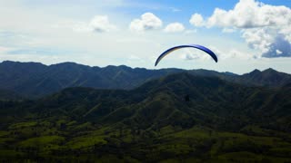 Skydiver flying over a mountain range