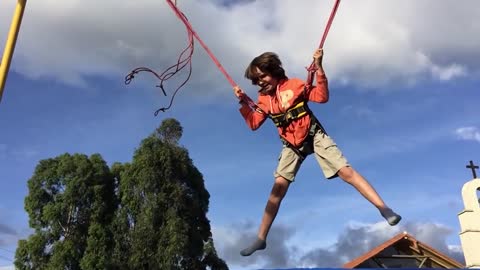 Kid Jumping On A Trampoline