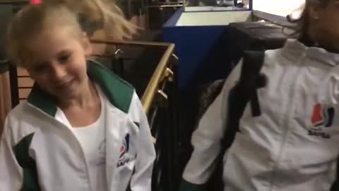 Girls in white jackets whipping hair smacks other in face